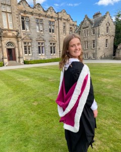 Image of a woman in her graduation gown